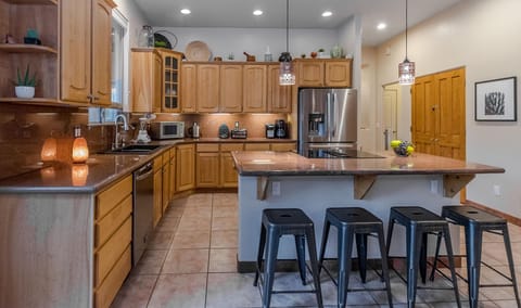 Spacious kitchen with granite countertops.