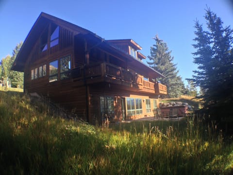 Back of the Newhard Chalet, showing deck and hot tub on patio