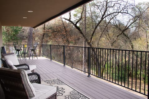 Large deck with plenty of patio furniture for entertaining