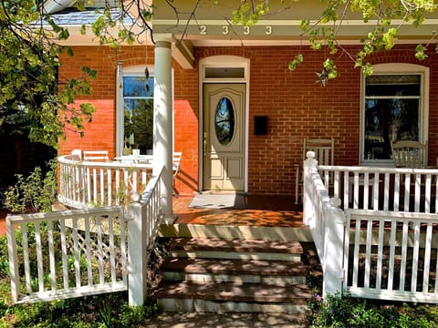 Sunny front porch with dining for 2 and 2 rocking chairs