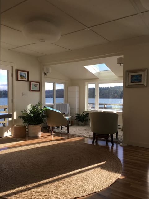 Living room bay window faces east across the Sound with a skylight for the stars