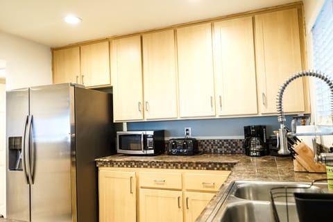 Kitchen with all essential appliances and enough plates and utensils for 8