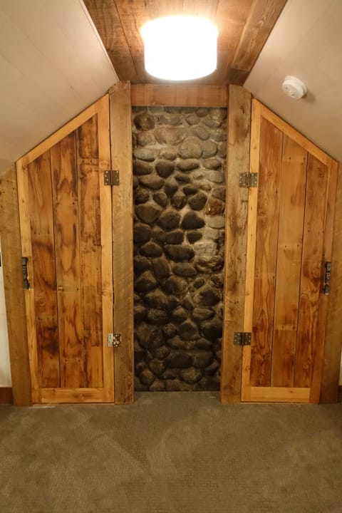 Bunk room doors closed revealing fireplace chimney