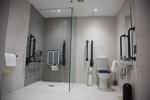 Suite, 1 King Bed, Accessible | Bathroom | Shower, designer toiletries, hair dryer, slippers