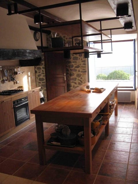 Fully equipped kitchen with a refrigerator, gas stove, oven, microwave, 