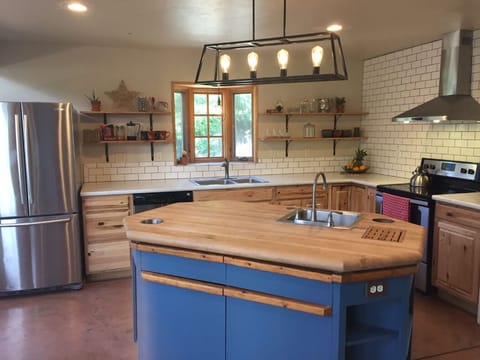 Full and spacious kitchen stocked with essentials and cooking utensils