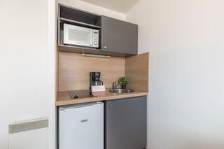 Studio, 2 Twin Beds | Private kitchen | Fridge, microwave, stovetop, coffee/tea maker