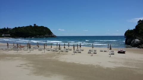 Private beach, white sand, sun loungers, beach umbrellas