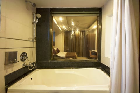 Deluxe Double or Twin Room, 1 King Bed | Bathroom | Combined shower/tub, rainfall showerhead, designer toiletries