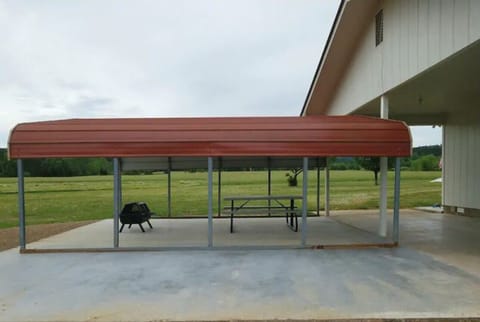Covered picnic area with fire pit (wood provided) , picnic table, and grill. 