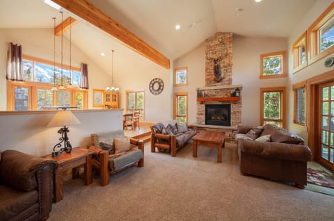 Spacious living room with cozy fireplace and mountain views