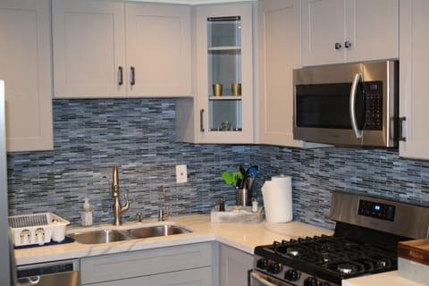 Completely brand new cabinets, back splash, microwave, countertops and stove