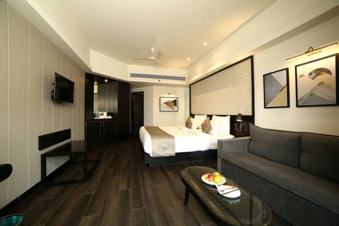 Super Deluxe Room | Living area | 34-inch TV with satellite channels