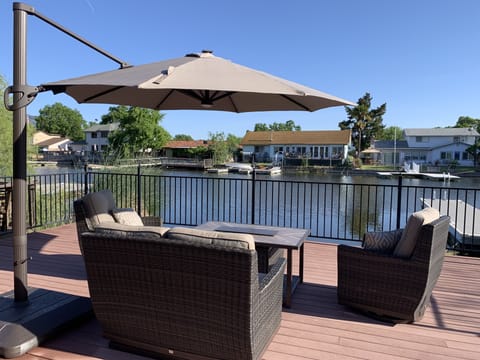 Outdoor sofa and fire pit to enjoy by the water. Watch kids at all times.