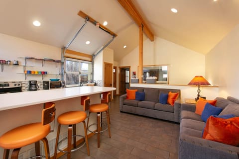 Kitchen, dining room and living room. Glass garage door opens up to courtyard. 