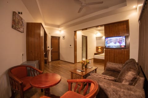 Luxury Studio Suite | Living area | Flat-screen TV