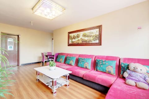 Three-Bedroom Apartment | Living area | Flat-screen TV