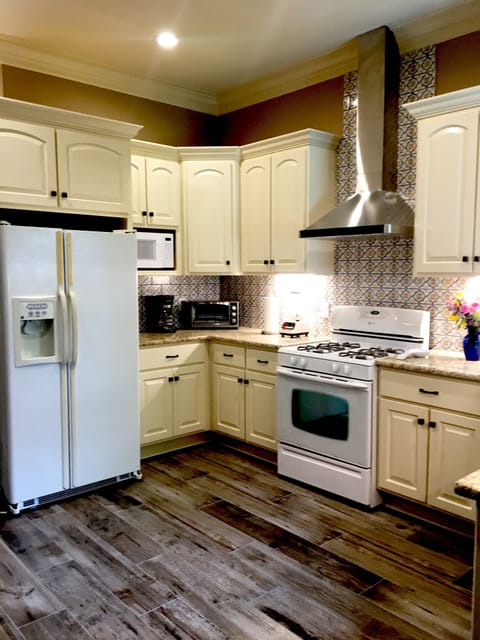 kitchen with beautiful counter top, backsplash and custom made cabinetry