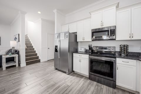 Spacious kitchen. Stairs lead to 2nd floor.