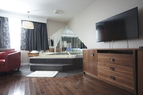 Romantic Suite, 1 Bedroom, Smoking, Hot Tub | Living area | 32-inch flat-screen TV with cable channels, TV