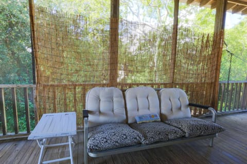 The seating area on the screened-in porch is perfect for reading a book or relaxing with your family.
