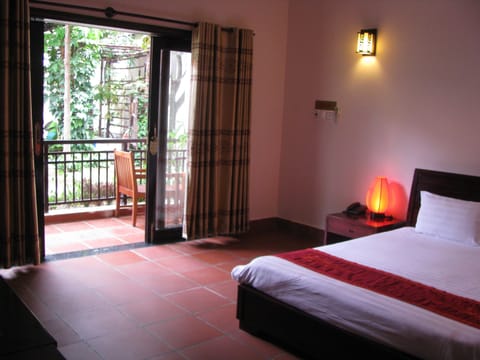 Deluxe Room, Garden View | Minibar, desk, blackout drapes, free WiFi