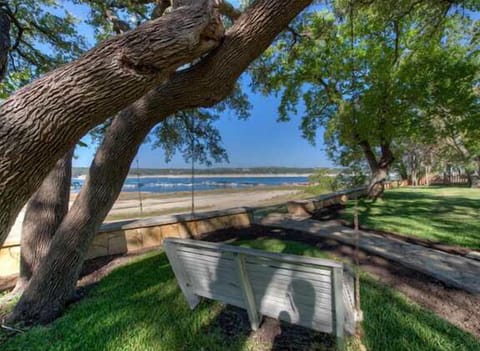 Large trees! Back of home (no swing). Sandy area belongs to local marina.