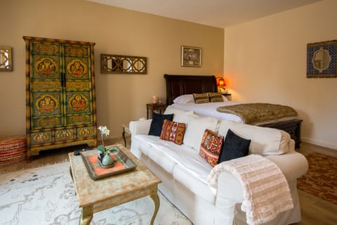 Queen sized bed, couch, and Tibetan Armoire.