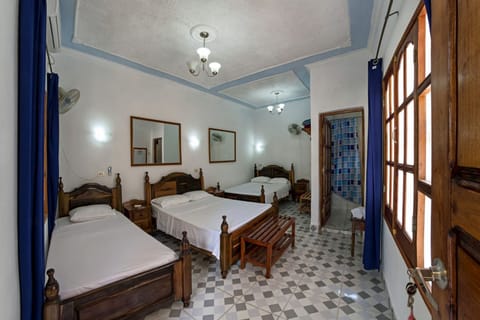 Family Triple Room | Iron/ironing board, bed sheets
