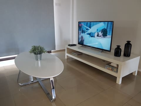 Apartment, 2 Bedrooms, Pool View | Living room | Flat-screen TV