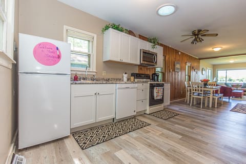 The kitchen is fully stocked with all cooking utensils, pots and pans.