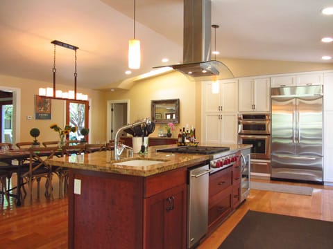 Gourmet kitchen with Wolf range and counter seating around cooking area.