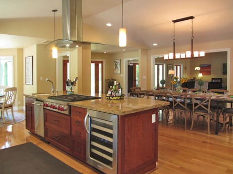 View of kitchen and dining area. Living room in background. Open architecture.