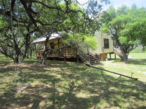 Front yard of Four Frio Sisters has teeter totter and swing to enjoy.
