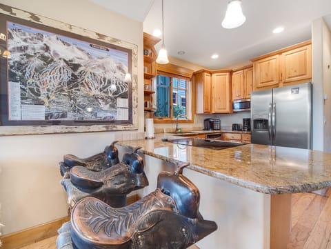 The three saddle barstools offer seating for 3.