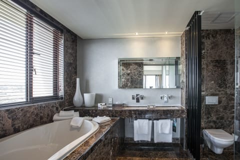 Suite | Bathroom | Separate tub and shower, rainfall showerhead, designer toiletries