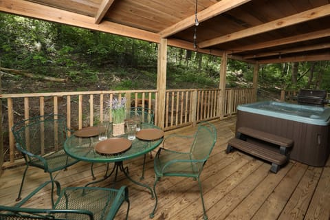 Outdoor eating area is adjacent to hot tub.