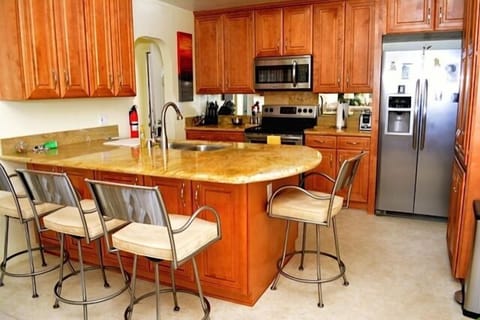Remodelled kitchen with stainless steel appliances and granite counter tops.