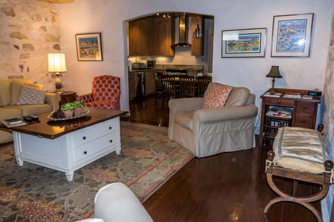 The kitchen has large opening into the living area. 