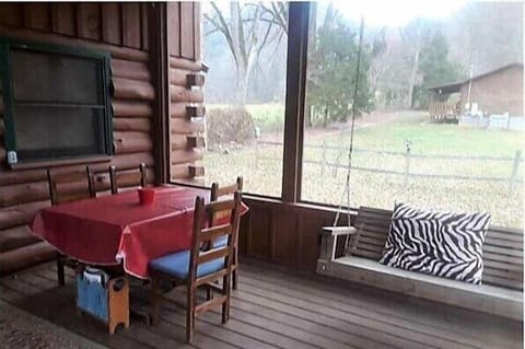 Outdoor dining & swing for relaxing on the screened in porch.