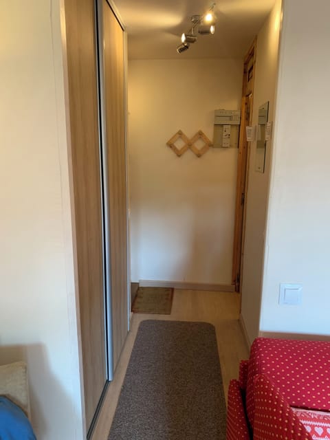 hallway with sliding wardrobe doors on the left, bathroom and separate toilet. 