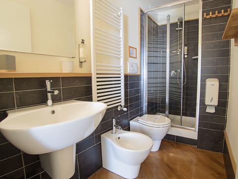 Family Quadruple Room, Balcony | Bathroom | Shower, rainfall showerhead, hair dryer, towels