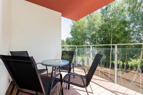 Spacious terrace with table and chairs.