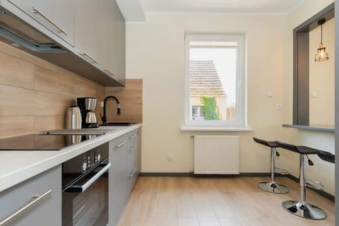 Kitchen with oven and refrigerator. 