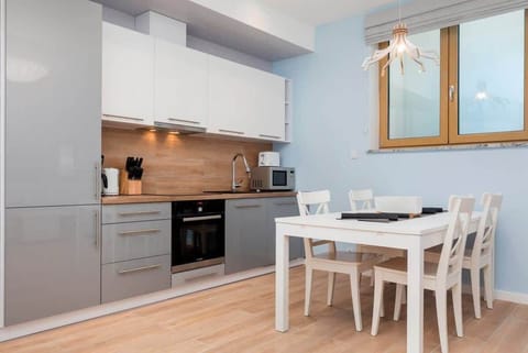 Kitchenette with oven and refrigerator. 