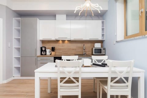 Kitchenette with oven and refrigerator. 