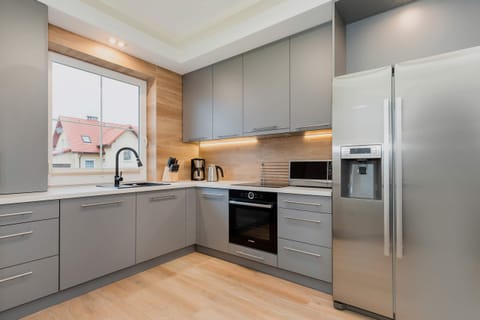 A fully equipped kitchen with sleek, stainless-steel appliances, spacious countertops, and modern cabinetry.