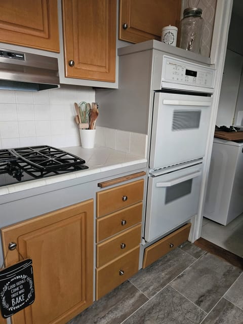 Kitchen-Aid appliances, gas range top and double convection ovens. 