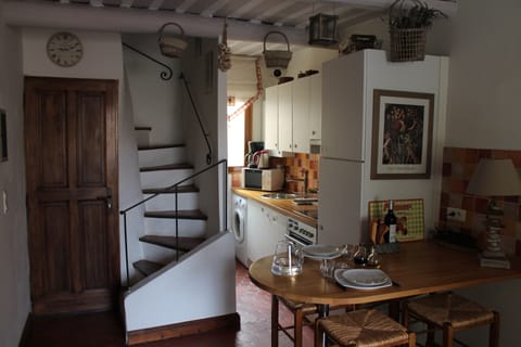 Dining area and kitchenenette, entrance door and stairs up to second level