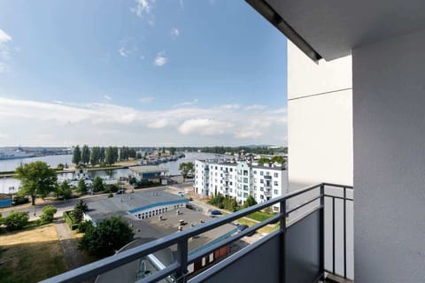 A balcony offering a view of the surrounding cityscape, providing an outdoor space to relax and enjoy the scenery.